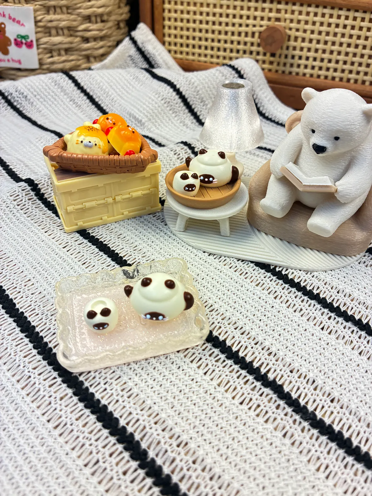 Mini animal and food-inspired silicone samples staged with a basket and reading bear display
