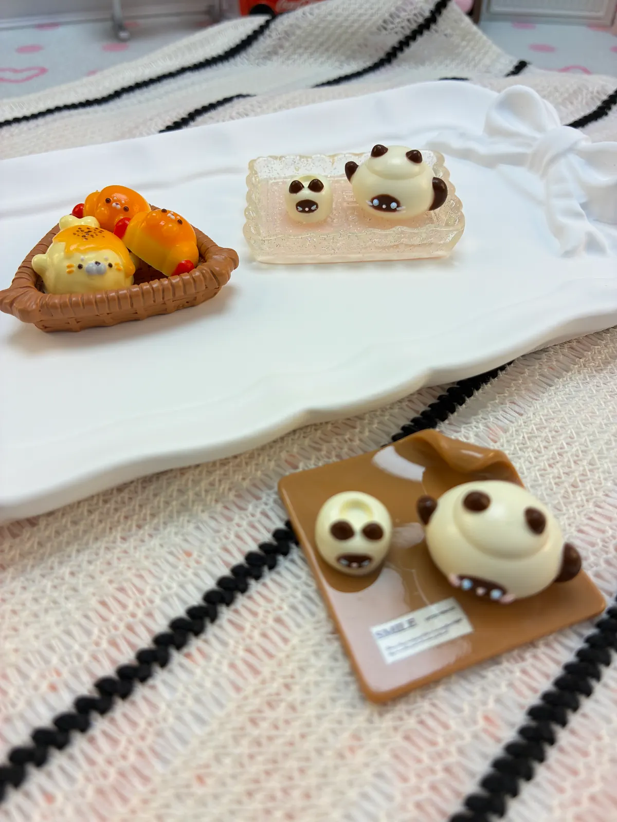 Handmade mini animal and food-inspired silicone squishy samples on small trays